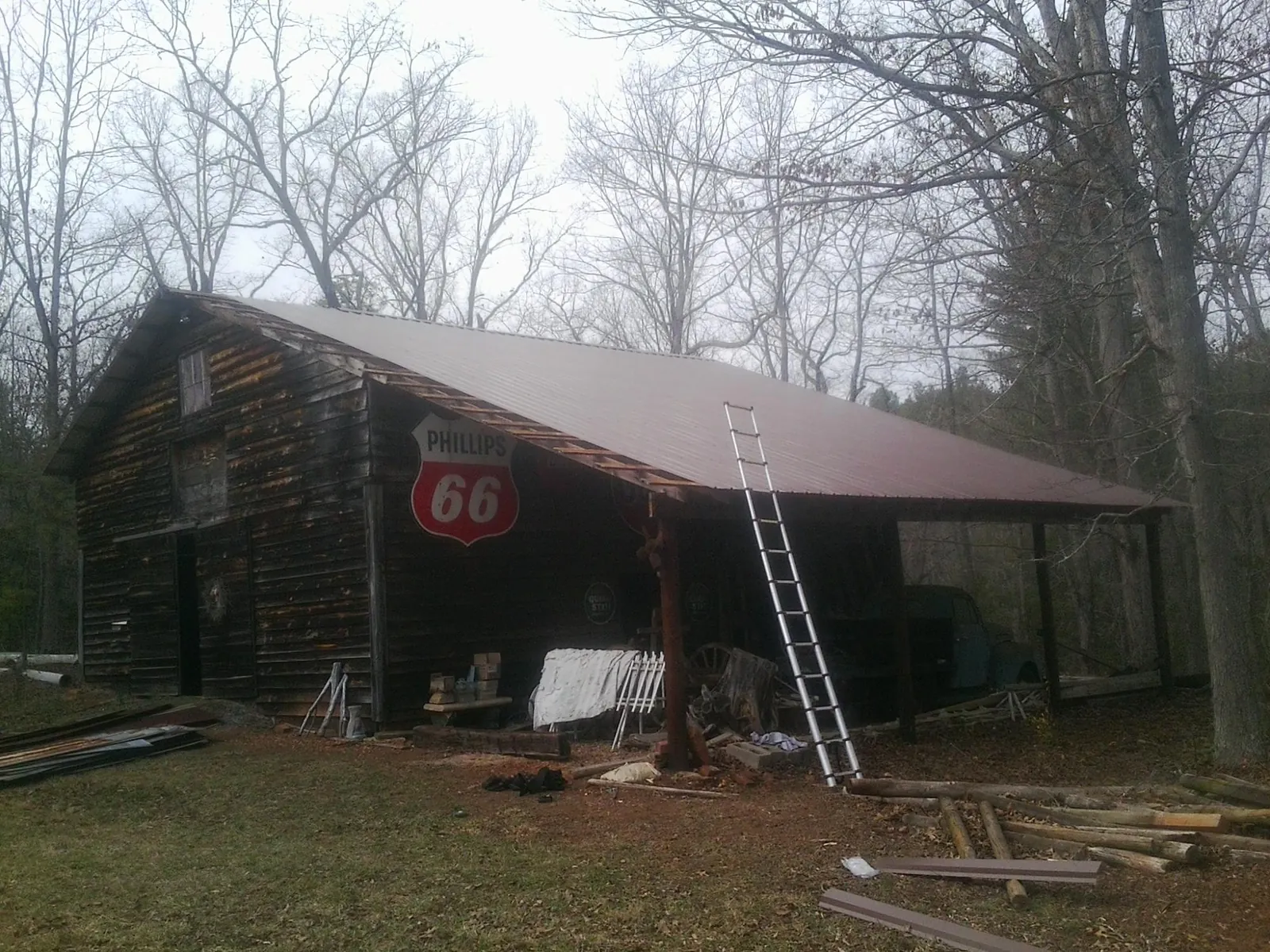 New metal roof on an open sided timber barn with a vintage sign in Humboldt